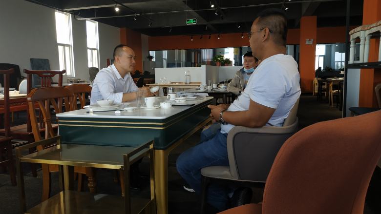 20210507/609550733e98b.jpg 西安博菲克家具廠楊總為客戶介紹餐桌椅材質.jpg